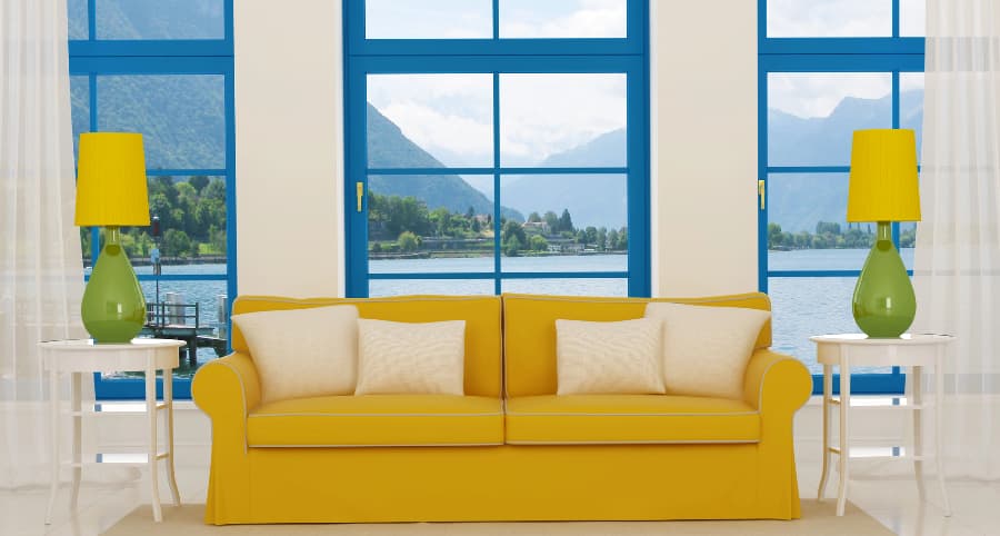 Image of family room windows behind sofa with coordinating lights and tables